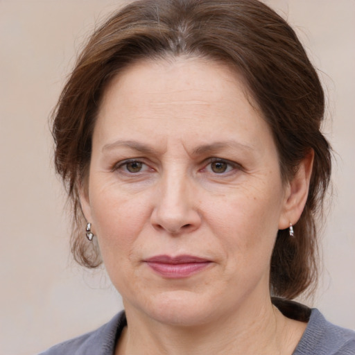 Joyful white adult female with medium  brown hair and grey eyes