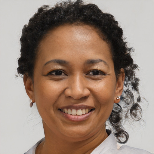 Joyful black adult female with short  brown hair and brown eyes