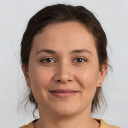 Joyful white adult female with medium  brown hair and brown eyes