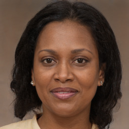 Joyful black adult female with medium  brown hair and brown eyes