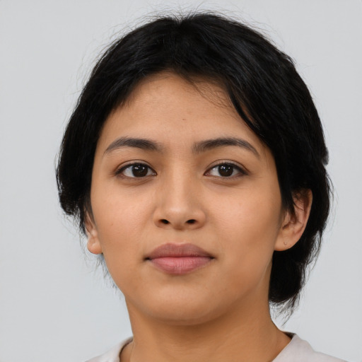 Joyful latino young-adult female with medium  black hair and brown eyes