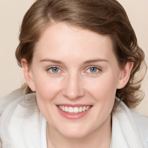 Joyful white young-adult female with medium  brown hair and blue eyes