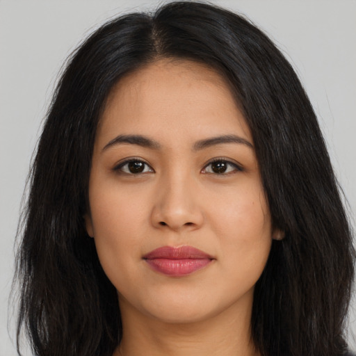 Joyful latino young-adult female with long  black hair and brown eyes