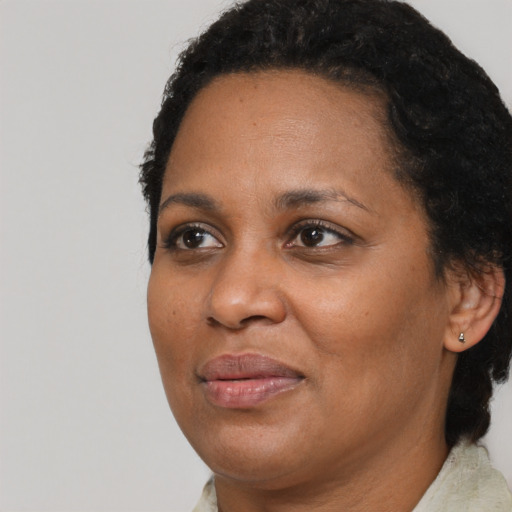 Joyful black adult female with short  brown hair and brown eyes