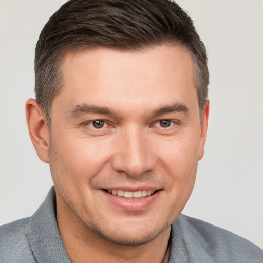 Joyful white young-adult male with short  brown hair and brown eyes