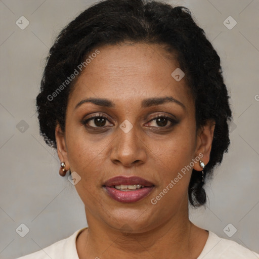 Joyful black adult female with short  brown hair and brown eyes