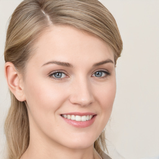 Joyful white young-adult female with long  brown hair and blue eyes