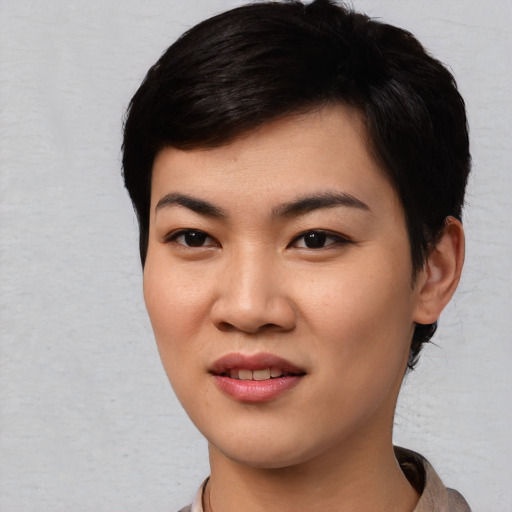 Joyful asian young-adult female with short  black hair and brown eyes