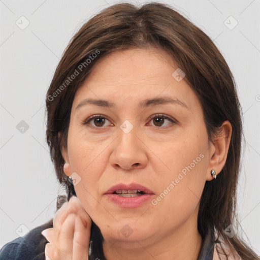 Joyful white adult female with medium  brown hair and brown eyes