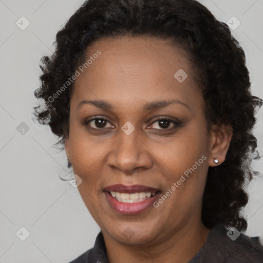 Joyful black adult female with medium  brown hair and brown eyes