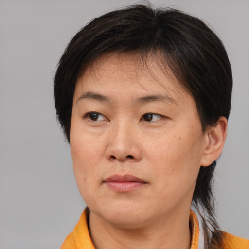 Neutral asian adult female with medium  brown hair and brown eyes