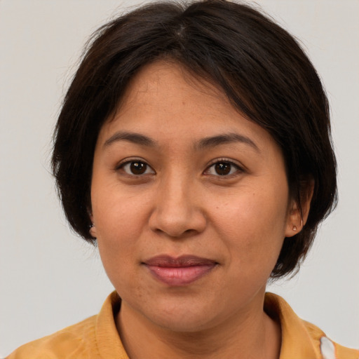 Joyful white adult female with medium  brown hair and brown eyes