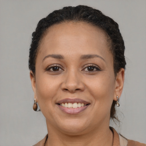 Joyful black adult female with short  brown hair and brown eyes