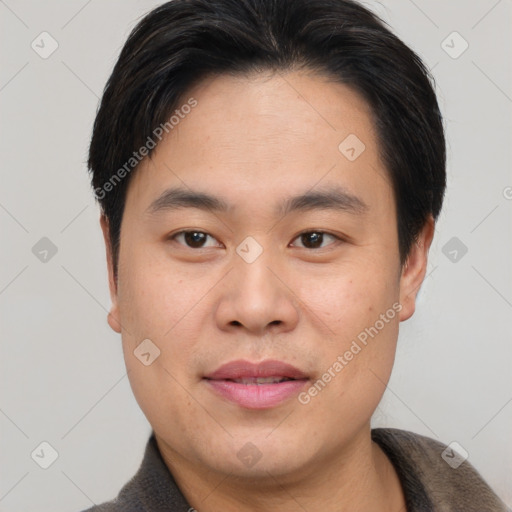 Joyful asian young-adult male with short  brown hair and brown eyes