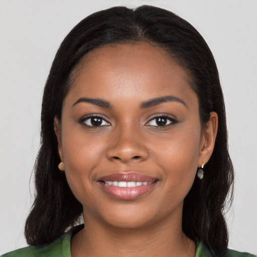 Joyful black young-adult female with long  brown hair and brown eyes