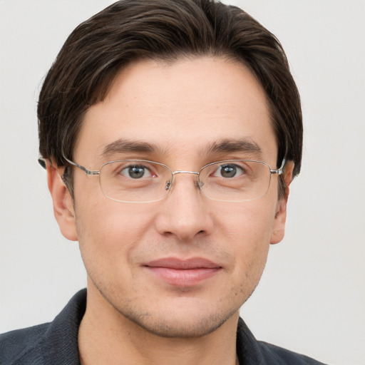 Joyful white adult male with short  brown hair and grey eyes