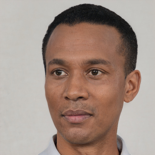 Neutral black adult male with short  black hair and brown eyes
