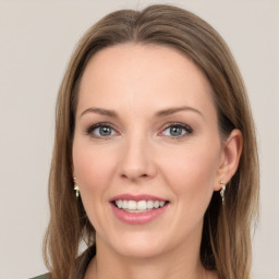 Joyful white young-adult female with long  brown hair and green eyes