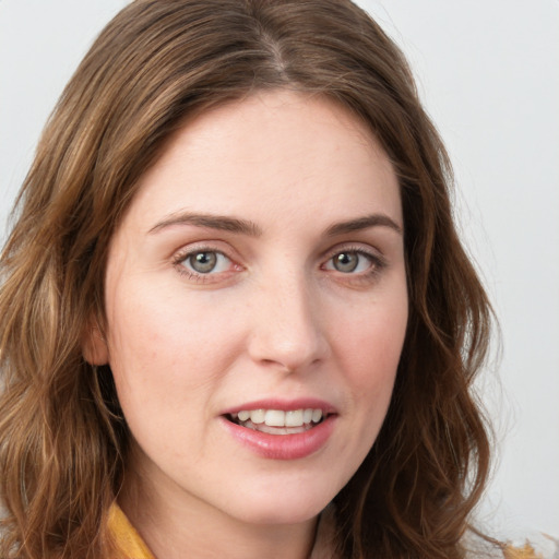 Joyful white young-adult female with long  brown hair and green eyes