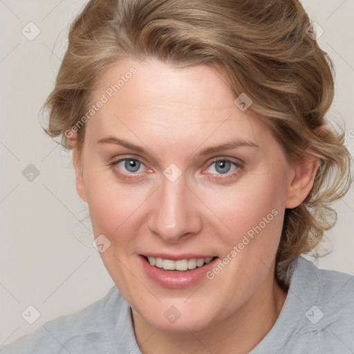 Joyful white adult female with medium  brown hair and blue eyes