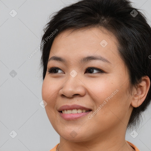 Joyful asian young-adult female with medium  brown hair and brown eyes