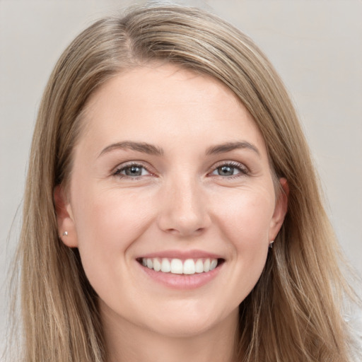 Joyful white young-adult female with long  brown hair and grey eyes