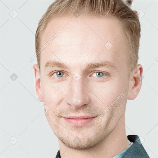 Joyful white young-adult male with short  brown hair and blue eyes