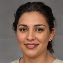 Joyful white adult female with medium  brown hair and brown eyes