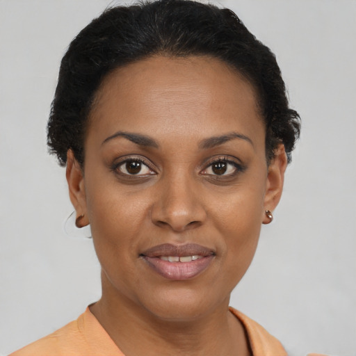 Joyful black young-adult female with short  brown hair and brown eyes