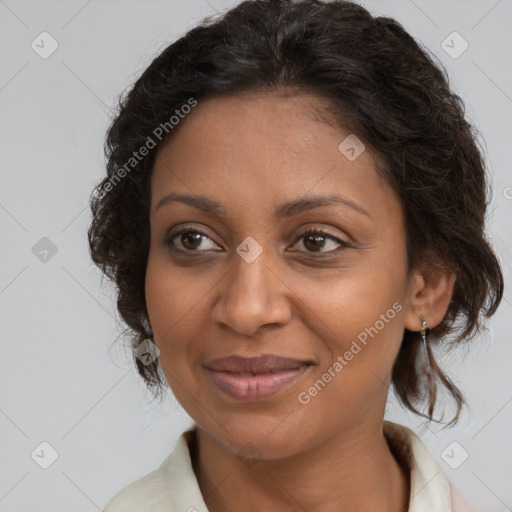 Joyful black adult female with medium  brown hair and brown eyes