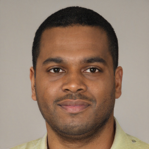 Joyful latino young-adult male with short  brown hair and brown eyes
