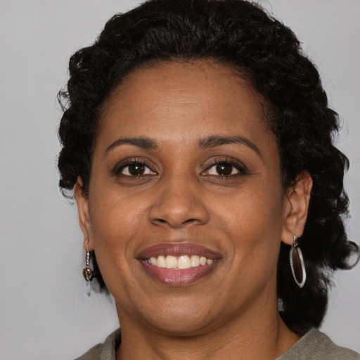 Joyful black young-adult female with medium  black hair and brown eyes