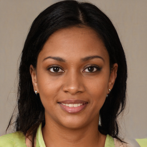 Joyful black young-adult female with medium  brown hair and brown eyes
