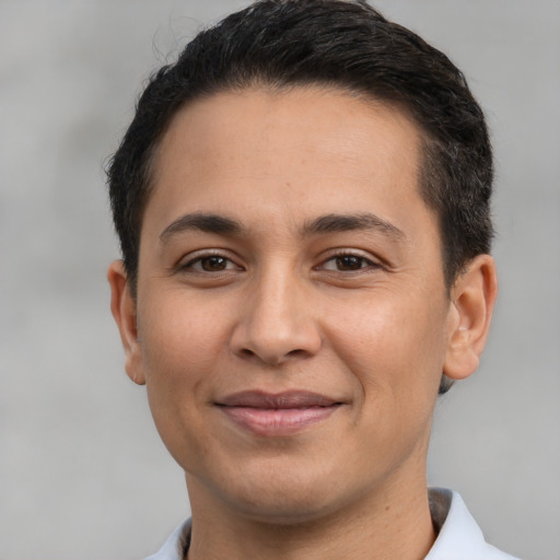 Joyful latino young-adult male with short  brown hair and brown eyes