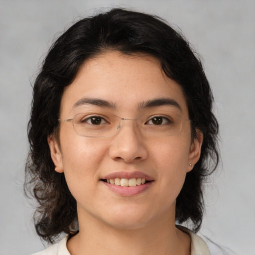 Joyful asian young-adult female with medium  brown hair and brown eyes