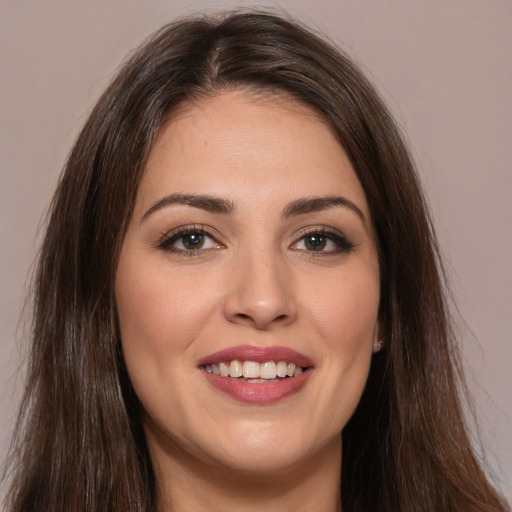 Joyful white young-adult female with long  brown hair and brown eyes