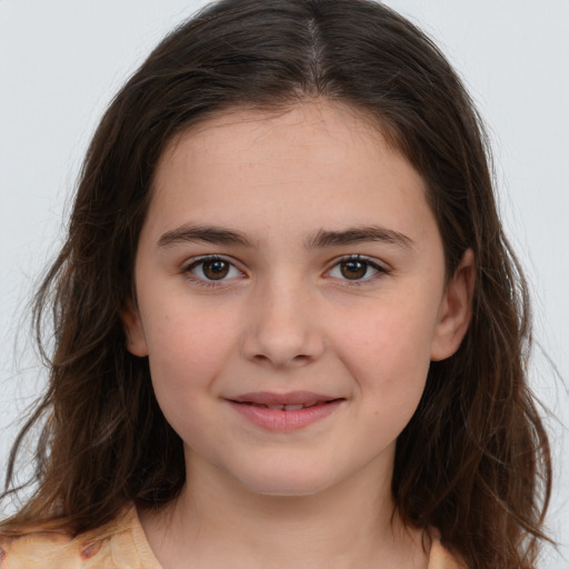 Joyful white child female with long  brown hair and brown eyes