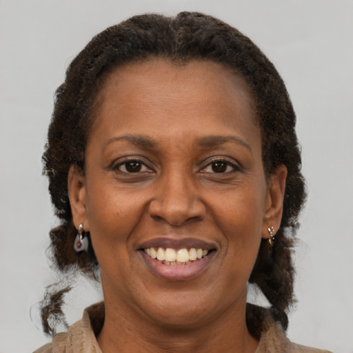 Joyful latino adult female with short  brown hair and brown eyes