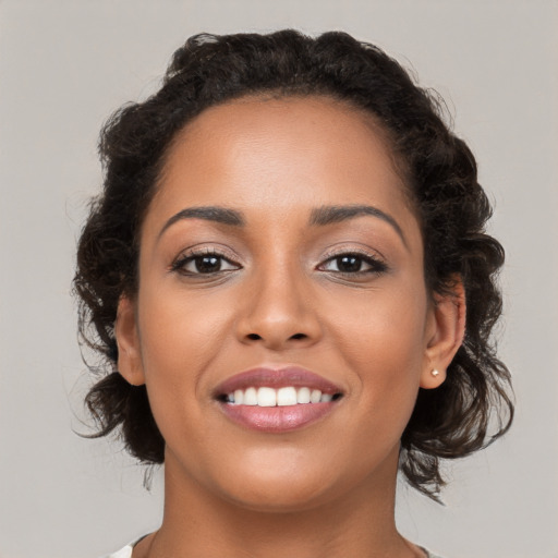 Joyful latino young-adult female with medium  brown hair and brown eyes