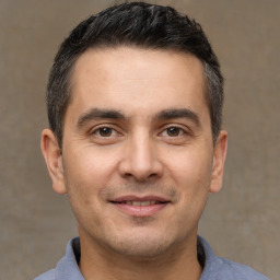 Joyful white adult male with short  brown hair and brown eyes