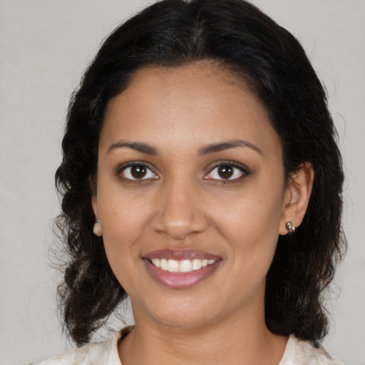 Joyful black young-adult female with medium  brown hair and brown eyes