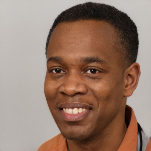 Joyful latino adult male with short  black hair and brown eyes