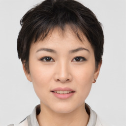 Joyful asian young-adult female with short  brown hair and brown eyes