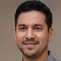 Joyful white young-adult male with short  black hair and brown eyes