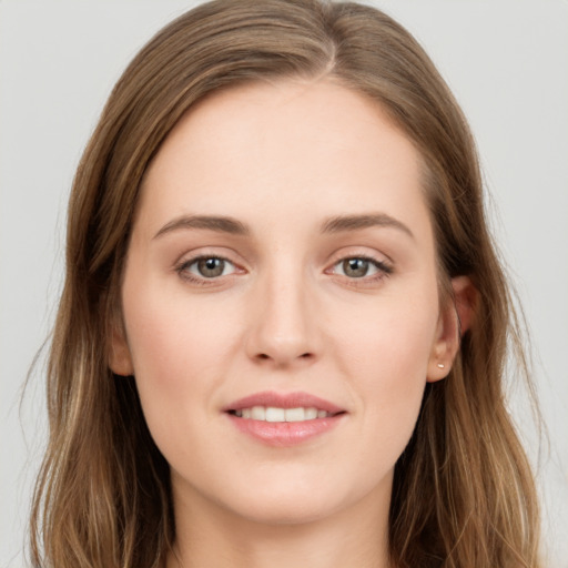 Joyful white young-adult female with long  brown hair and grey eyes