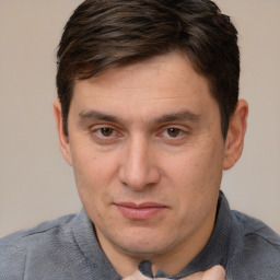 Joyful white adult male with short  brown hair and brown eyes