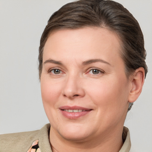 Joyful white adult female with short  brown hair and brown eyes