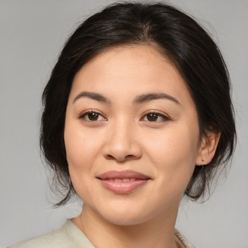 Joyful asian young-adult female with medium  brown hair and brown eyes