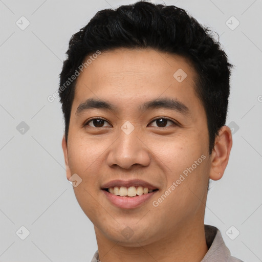 Joyful asian young-adult male with short  black hair and brown eyes