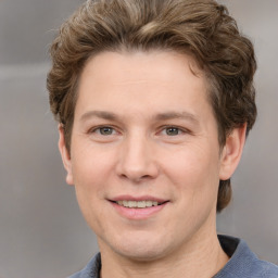 Joyful white adult male with short  brown hair and grey eyes